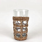 Be Home rattan cage highball glass in hand-woven rattan over clear glass, front view