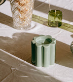 The Socialite Family Candela orange blossom scented candle in a green ceramic vessel, 240g, styled in a room setting