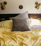 The Socialite Family Carino square cushion in brown and green tweed-effect fabric, 45x45cm, styled in a room setting 2