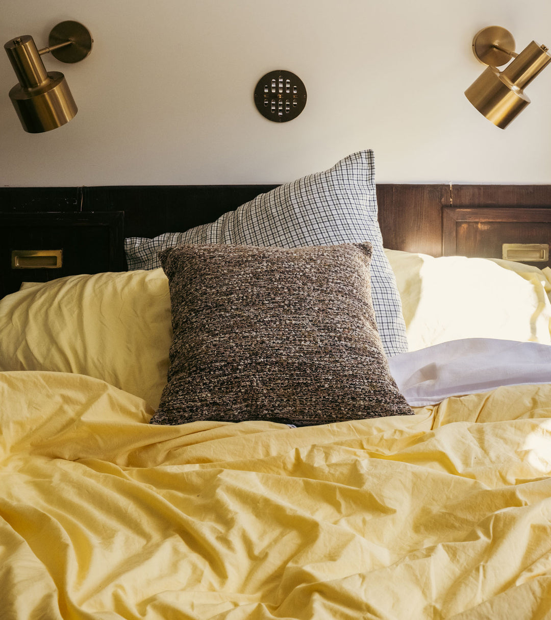 The Socialite Family Carino square cushion in brown and green tweed-effect fabric, 45x45cm, styled in a room setting 2